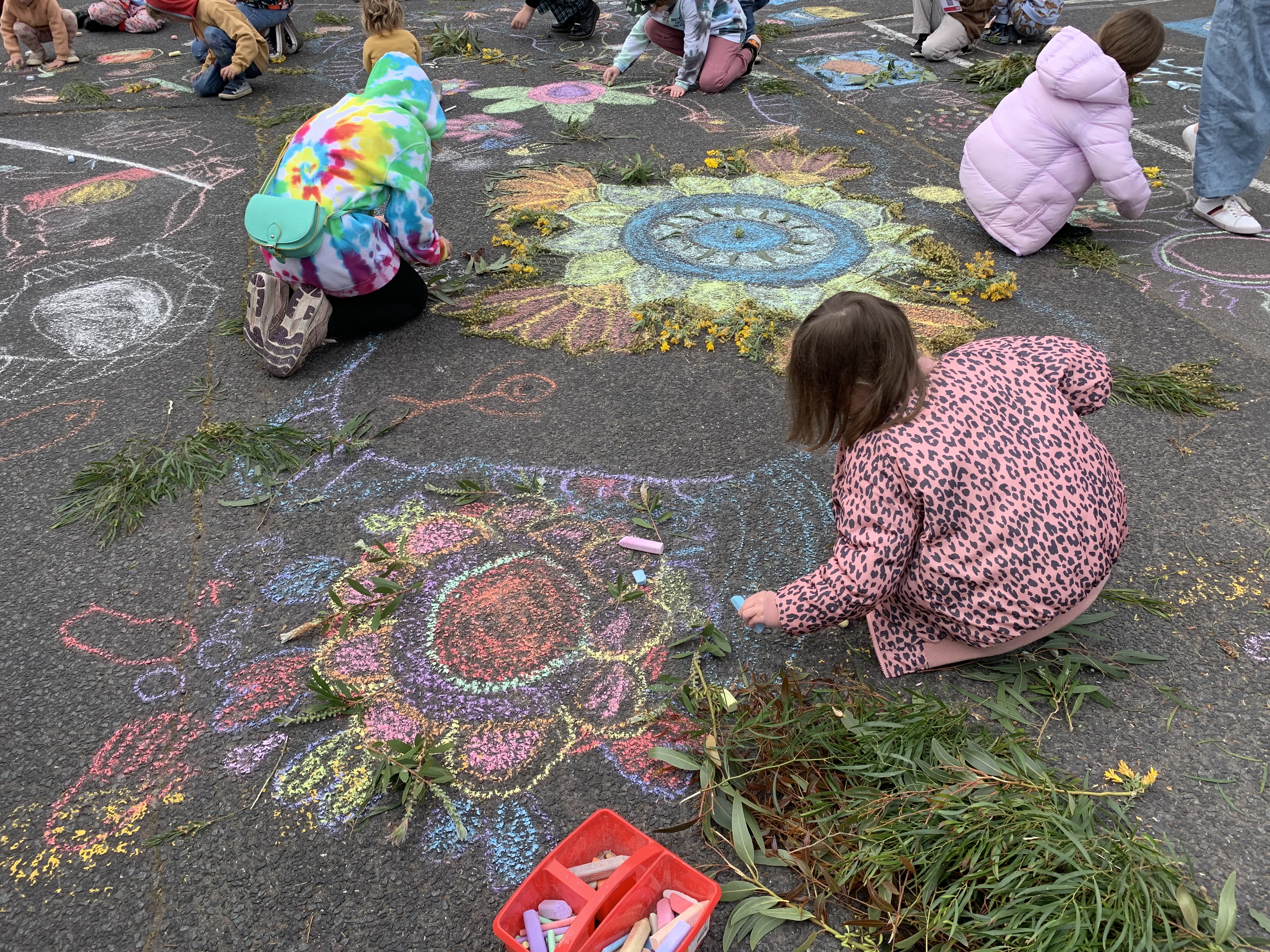 Kids drawing with chalk on the pavement at Lift Off launch