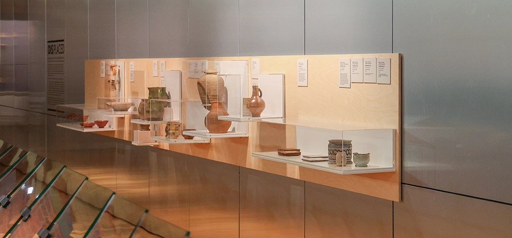 glass cabinet with various ceramic vessels
