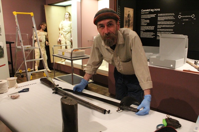 Russel Lewis-Jones prepares a rifle for storage