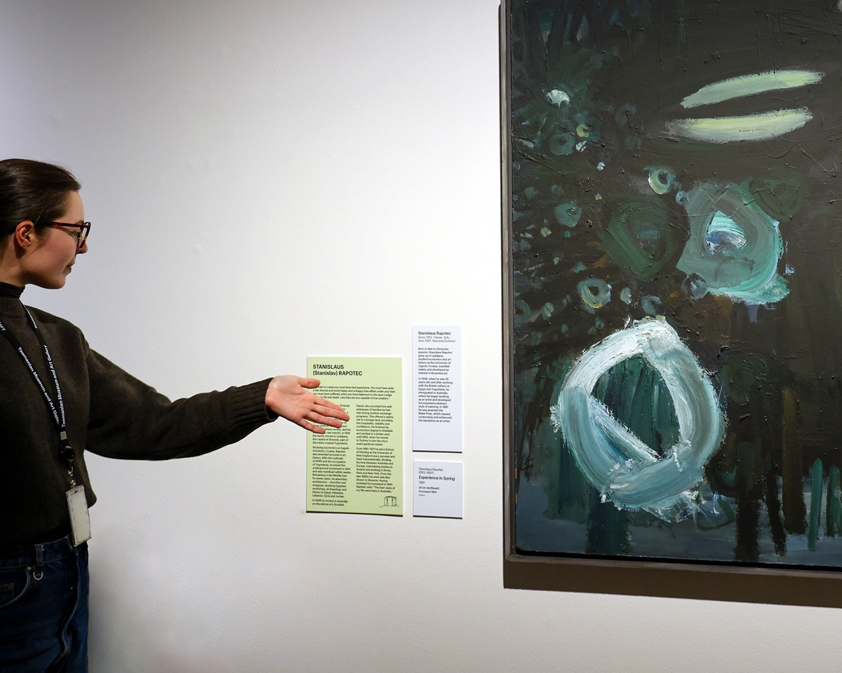 TMAG staff displaying a painting