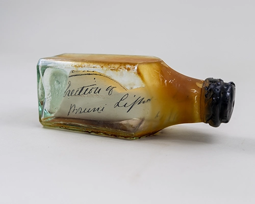 Small glass bottle containing a handwritten note.
