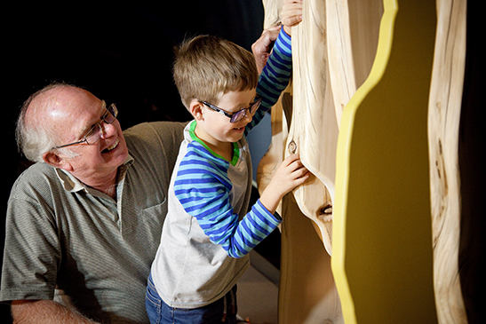 Grandfather and grandchild in gallery